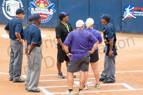 Umpires and coaches meeting at home plate